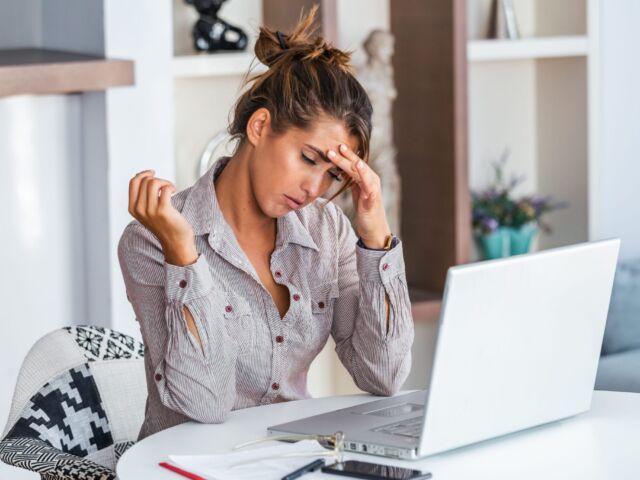 Tired-Frustrated-woman_in_gray_dress_shirt_sitting_on_chair-scopio-2b6d7bf3-6723-42aa-baba-683768d81fa6-scaled